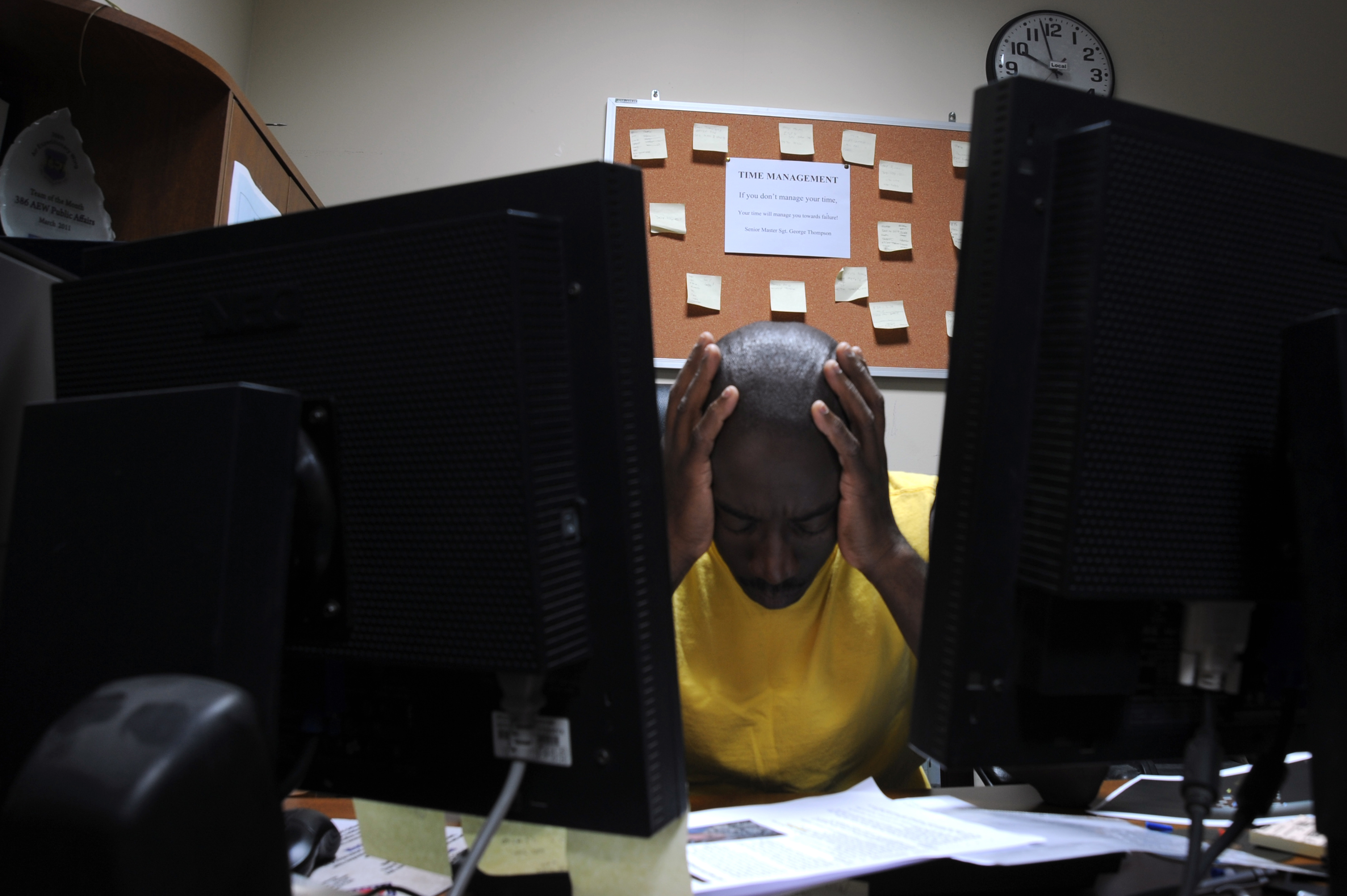 Image of a SNCO touching his head with both hands